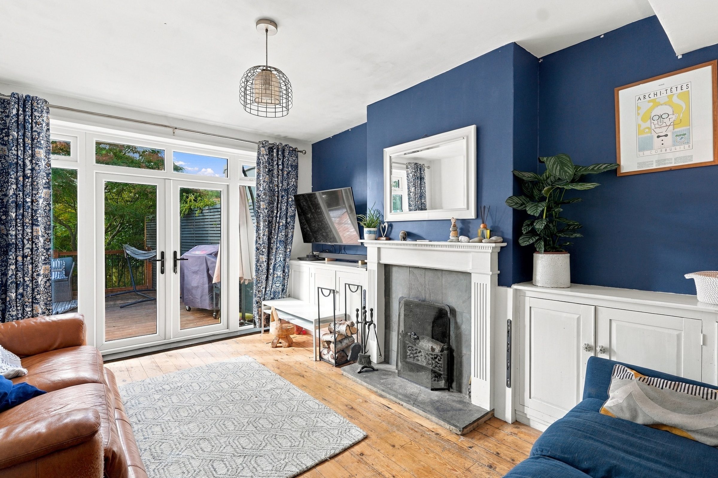 Sitting room with French doors and an open fireplace